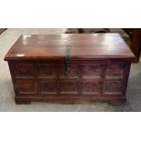 A stained wood blanket chest with panelled front a