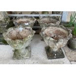 A set of four stone effect garden planters of foli