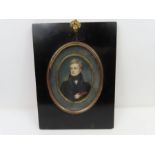 An early 19th century oval miniature portrait on i