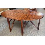 A mid century rosewood drop leaf dining table with