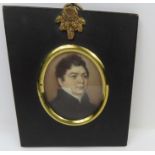 An early 19th century oval miniature portrait of a