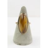 A tigers eye dress ring, the band marked '9ct', fi