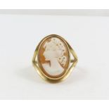 A 9ct gold orange shell cameo ring, with split sho