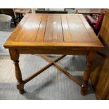 An oak draw leaf table on turned supports together