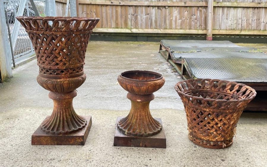 A pair of cast iron garden urn shaped planters of
