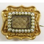 A Victorian gold mourning brooch, the hair panel w