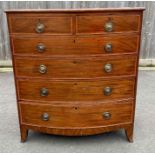 An early 19th century bow fronted mahogany chest o