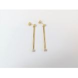 A pair of drop earrings set with white stones, tes