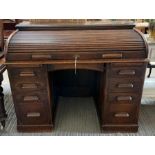 An early 20th century oak roll top desk, the tambo