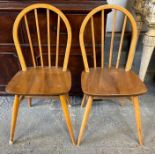 A pair of Ercol stick back Windsor chairs with sha