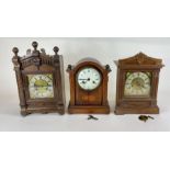 Three Victorian mantel clocks in wooden architectu