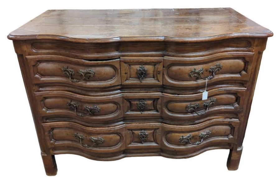 An 18th century French oak serpentine commode,