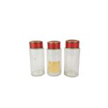 Three tall glass storage jars with painted metal c