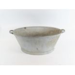 An old galvanised two handled wash tub 27cm high