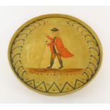 A circular painted wood tray with naïve portrait o