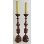 A pair of tall, turned yew wood pricket candle hol