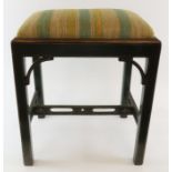 A painted wood stool with drop-in upholstered seat