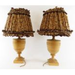 A pair of walnut turned lamps and matching shades,