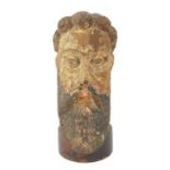 A carved polychrome limewood head of a male with a