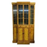 A tall breakfront cabinet with painted decoration,