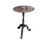 A mahogany and stained wood circular pedestal tabl