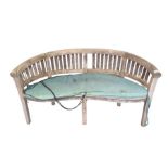 A hardwood garden bench in a semi circle shape, ap