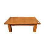 A rectangular oak coffee table of cleated form on