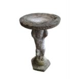 A birdbath, the base modelled as a cherub w