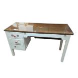 A rectangular painted wood desk with plate glass a