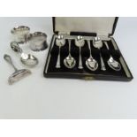 A set of six silver tea spoons , two silver napkin