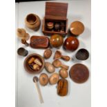 A quantity of treen includes scoops, finials, oliv