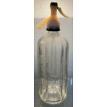 A clear glass soda syphon etched “Gibbs New & Co L