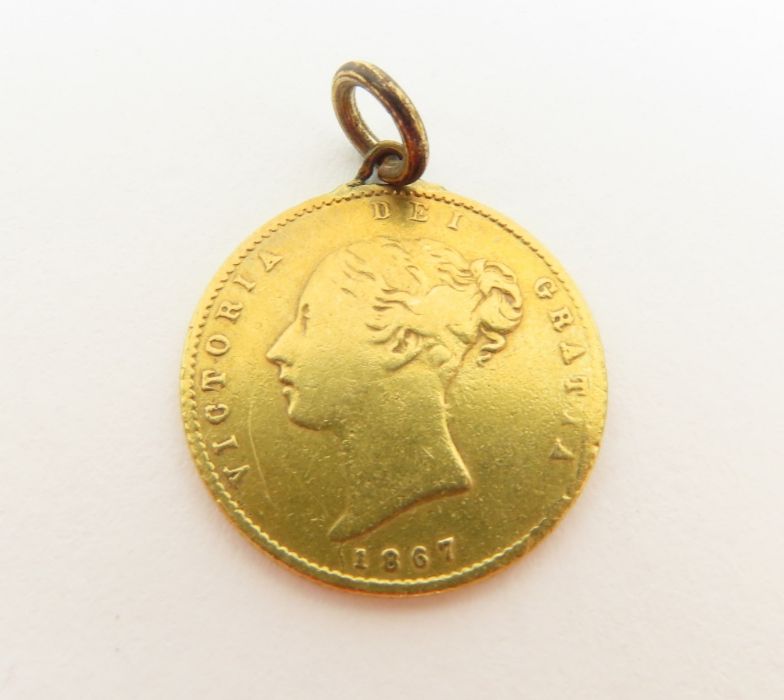 An 1867 shield back half sovereign with soldered fitting, 3.9 grams gross