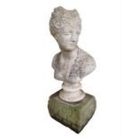 A classical bust of a female with flowers in her h