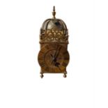 A brass lantern clock with short pendulum and key