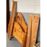 A pine double bed the arched headboard with swan d