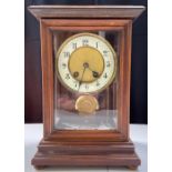 An Edwardian mantel clock in stained wood case wit