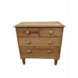 A Victorian stripped pine chest of two short and t
