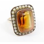 A large citrine and seed pearl dress ring, the lar