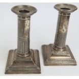 A pair of loaded silver desk candlesticks, by Gold