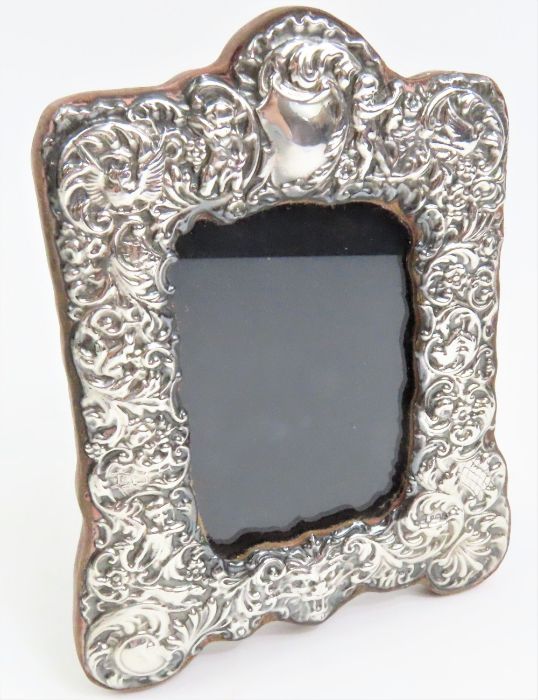 A silver photograph frame, in the Victorian style,
