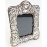 A silver photograph frame, in the Victorian style,