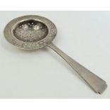 A tea strainer, stamped with an 84 mark, possibly