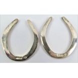 A pair of cased silver lucky horseshoe napkin ring