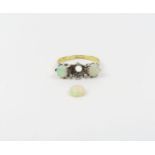 A three stone white opal ring, marked '18ct plat',