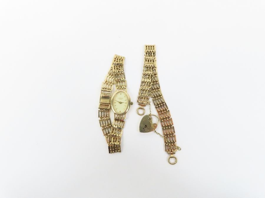 A 9 carat gold gate link style bracelet; with a