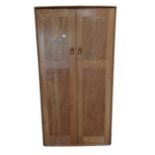 An Ercol double two door wardrobe with hanging rai