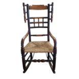 A Victorian mahogany rocking chair, with rush seat