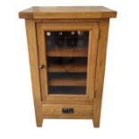 A modern oak display cabinet, with three shelves a