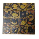 A Royal Copenhagen tile decorated with stylised bi